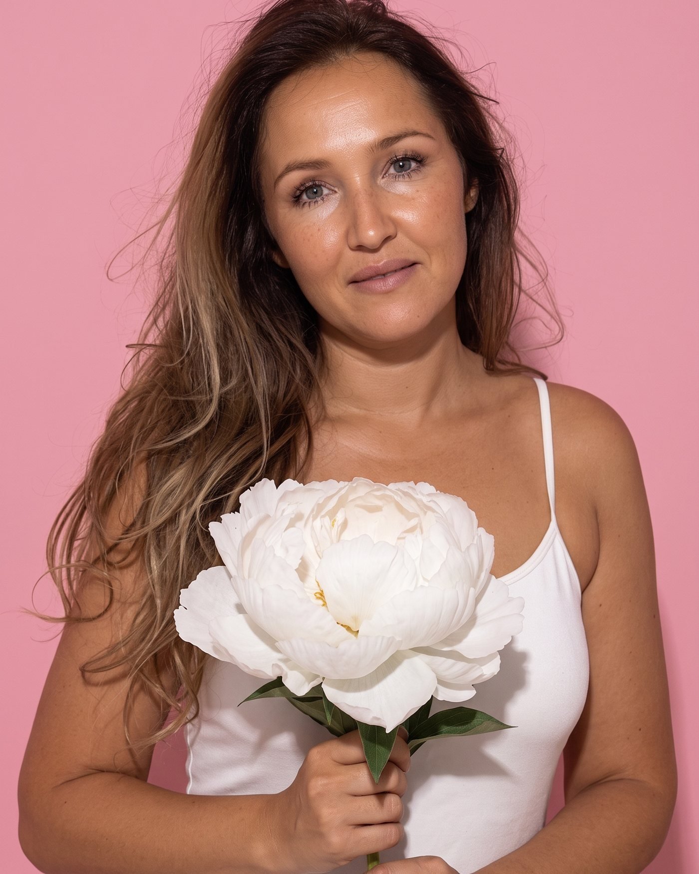 Jekaterina, Kat, smiling on a pink background