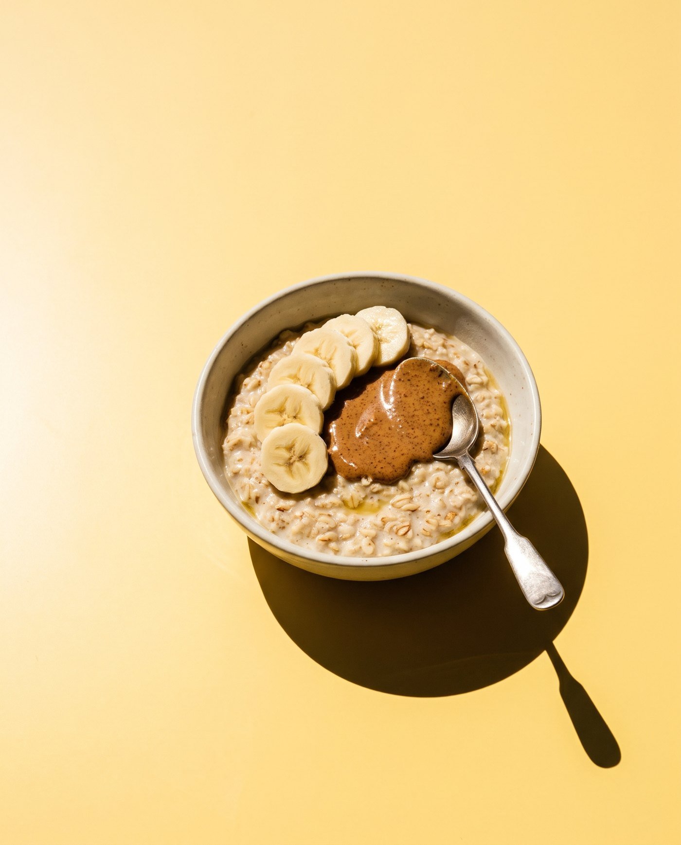 Warm oats with banana and a spoon of nut butter